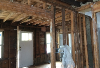 This is looking from the dining room into the living room. Scary part of this is that when the ceiling was torn down, some of the upstairs was missing some floor boards.